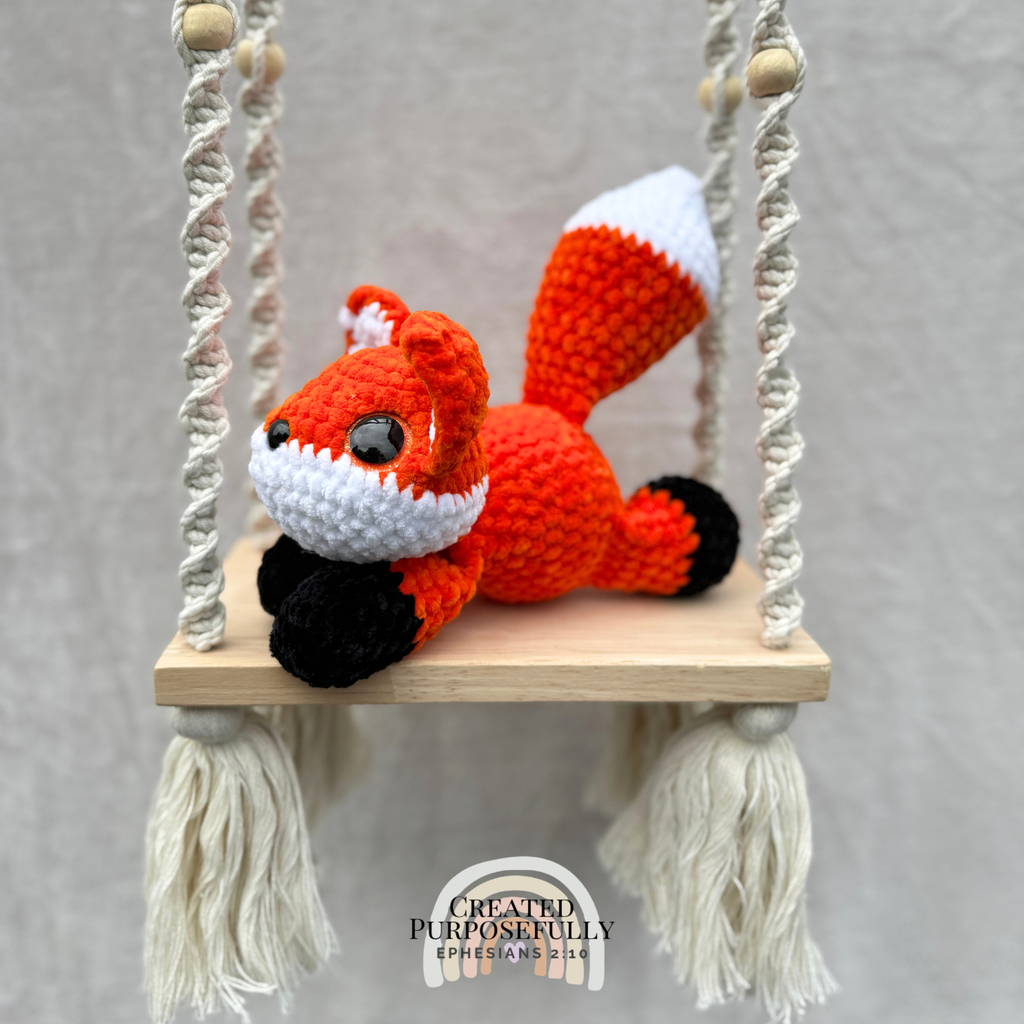 Handmade crochet fox plush with pointed ears and a fluffy tail made with soft cuddly yarn by Created Purposefully
