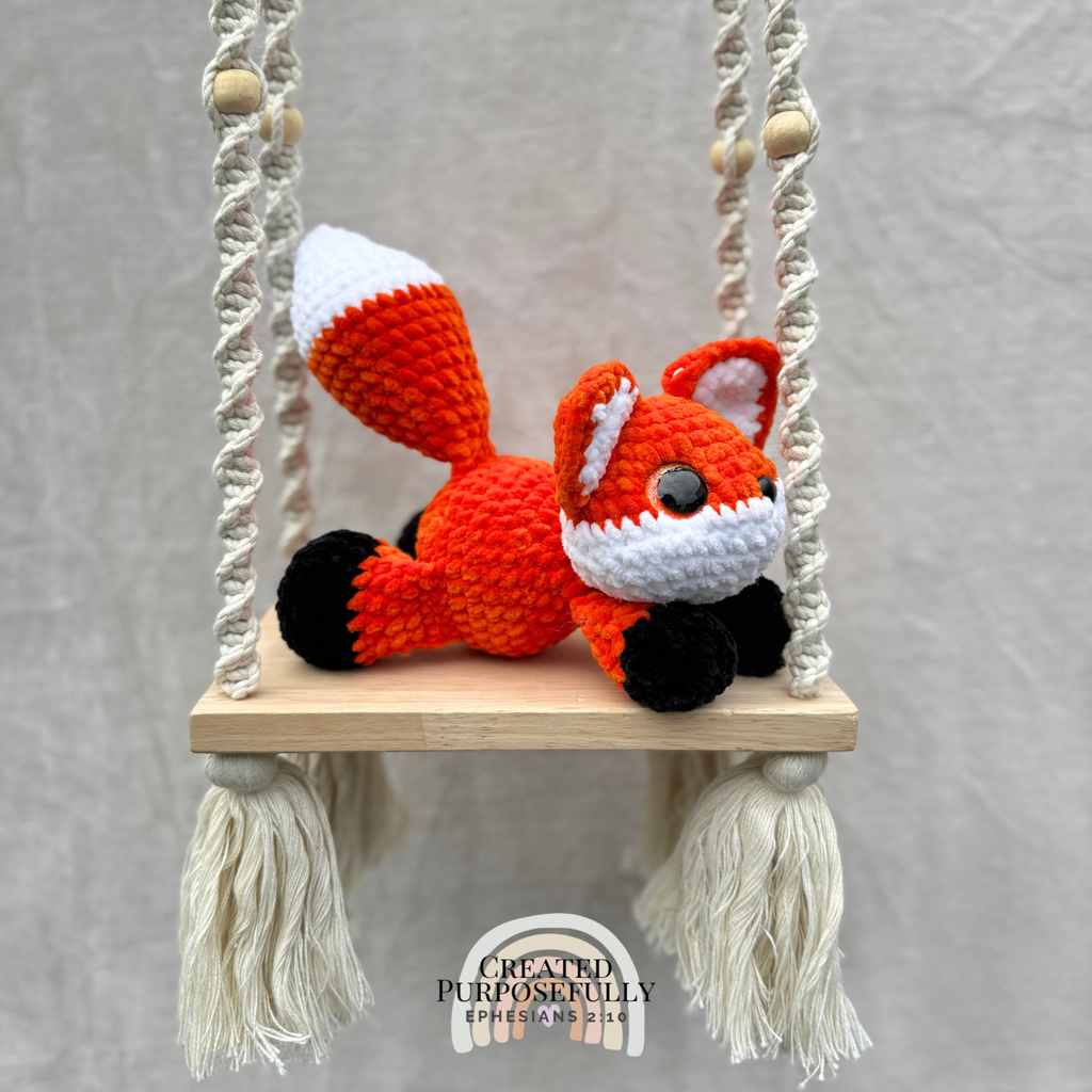 Handmade crochet fox plush with pointed ears and a fluffy tail made with soft cuddly yarn by Created Purposefully