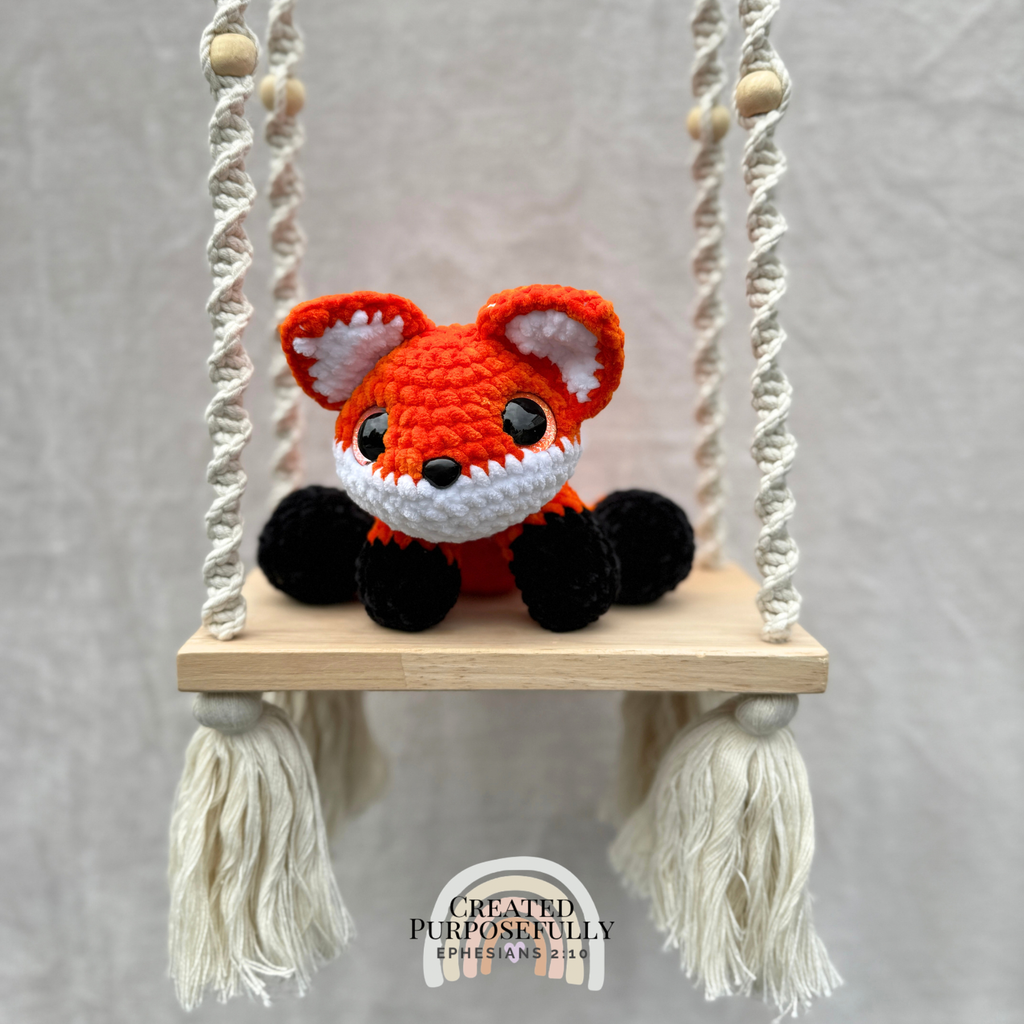 Handmade crochet fox plush with pointed ears and a fluffy tail made with soft cuddly yarn by Created Purposefully