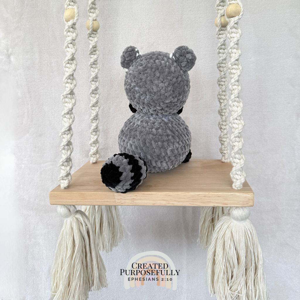 Handmade crochet raccoon plush with a classic masked face made with soft cuddly yarn by Created Purposefully