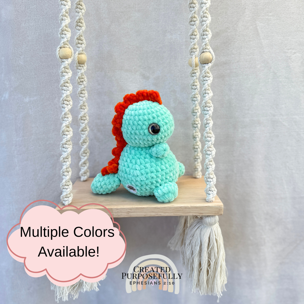 Handmade crochet Stegosaurus dinosaur plush with colorful back plates and soft cuddly yarn by Created Purposefully