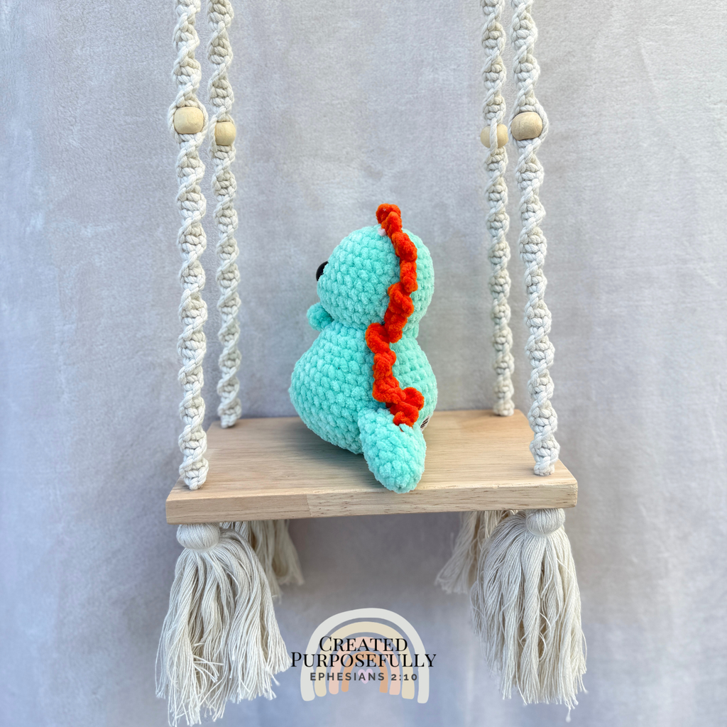 Handmade crochet Stegosaurus dinosaur plush with colorful back plates and soft cuddly yarn by Created Purposefully