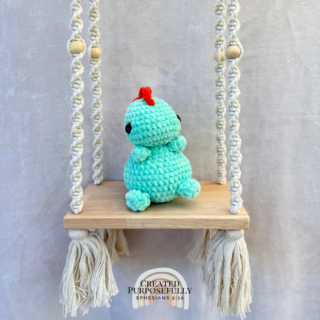 Handmade crochet Stegosaurus dinosaur plush with colorful back plates and soft cuddly yarn by Created Purposefully
