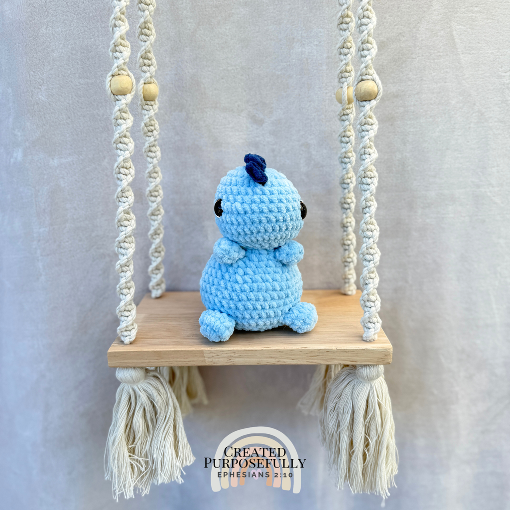 Handmade crochet Stegosaurus dinosaur plush with colorful back plates and soft cuddly yarn by Created Purposefully