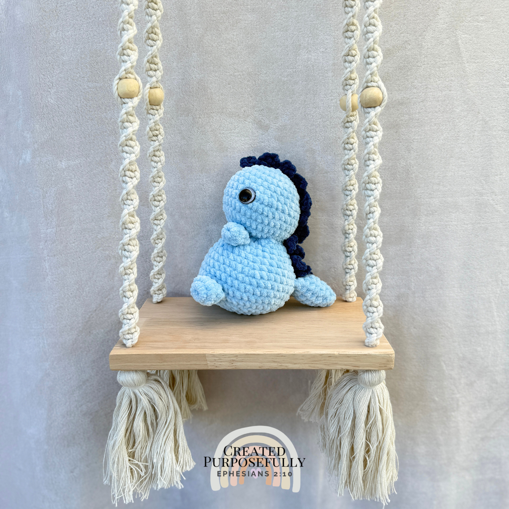 Handmade crochet Stegosaurus dinosaur plush with colorful back plates and soft cuddly yarn by Created Purposefully
