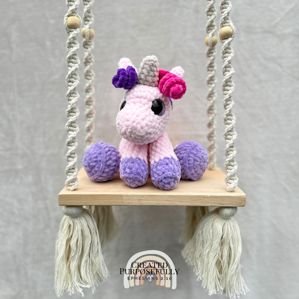 Handmade crochet unicorn plush with a magical horn and colorful mane made with soft cuddly yarn by Created Purposefully