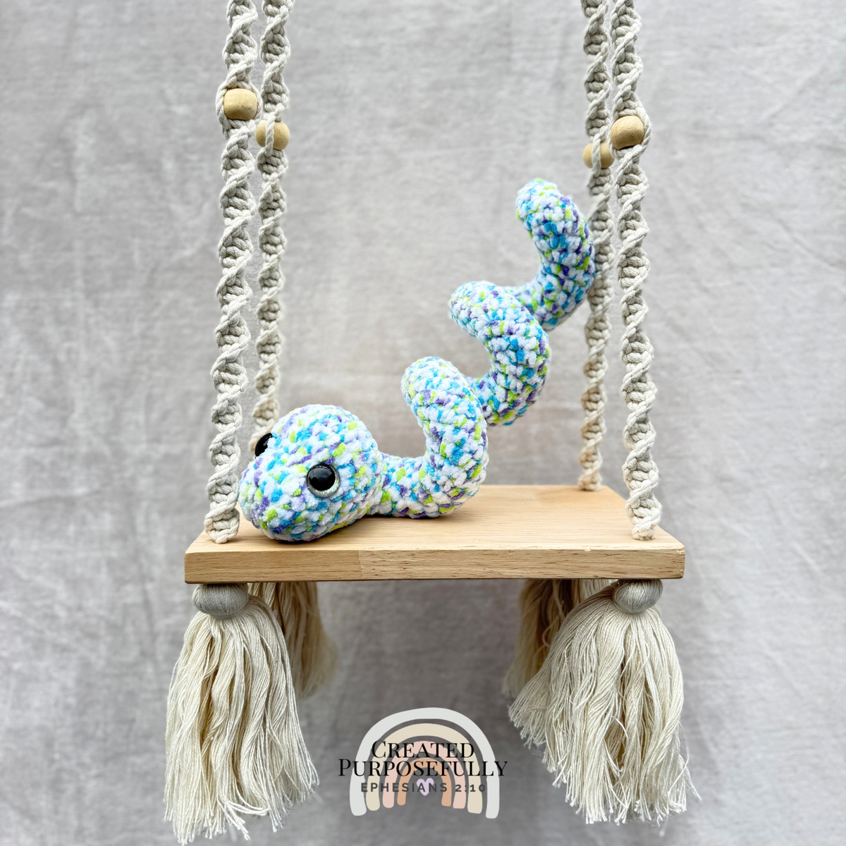 Handmade curled crochet snake plush in a coiled shape made with soft cuddly yarn by Created Purposefully