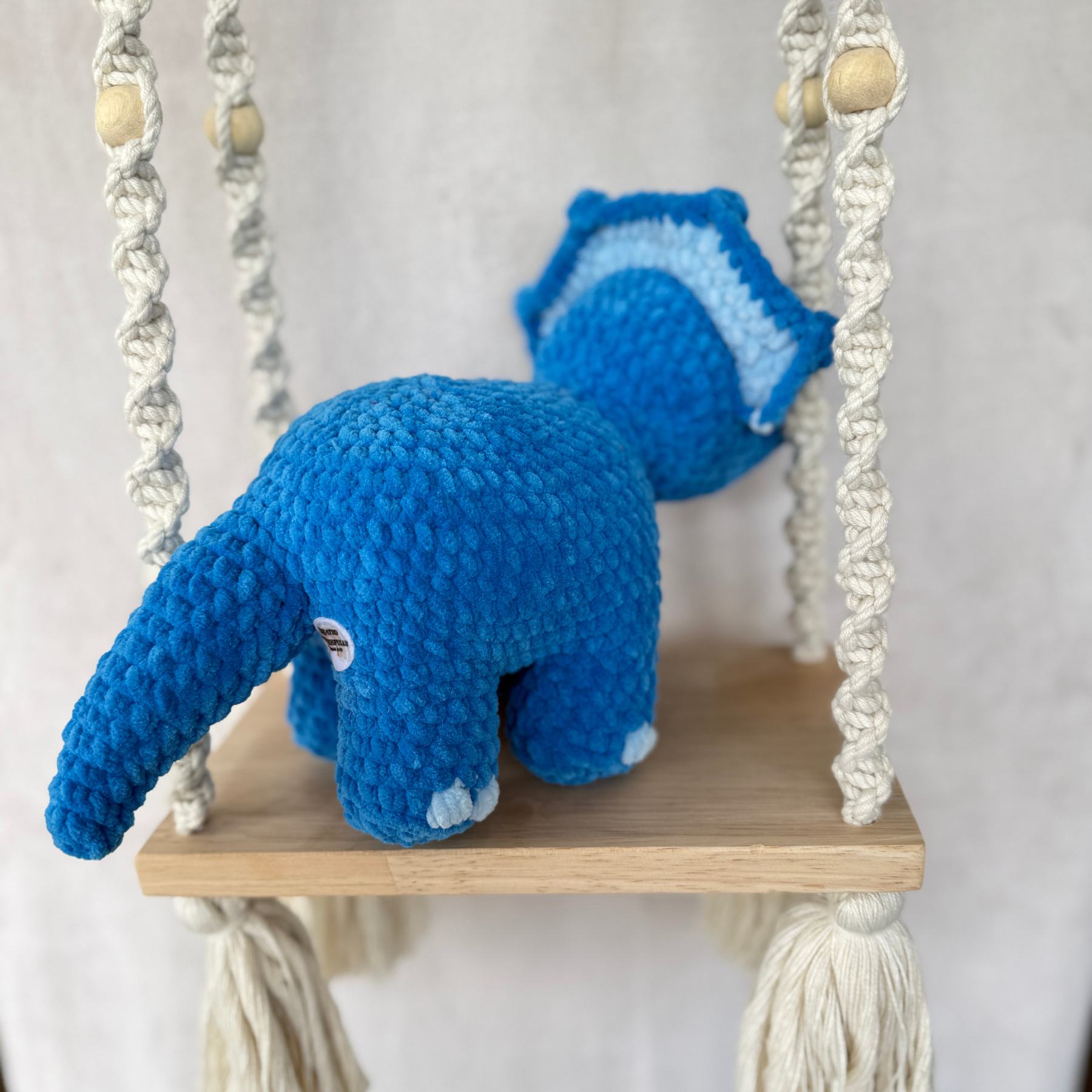 Handmade blue standing triceratops crochet plush made with soft plush yarn and adorable dinosaur details