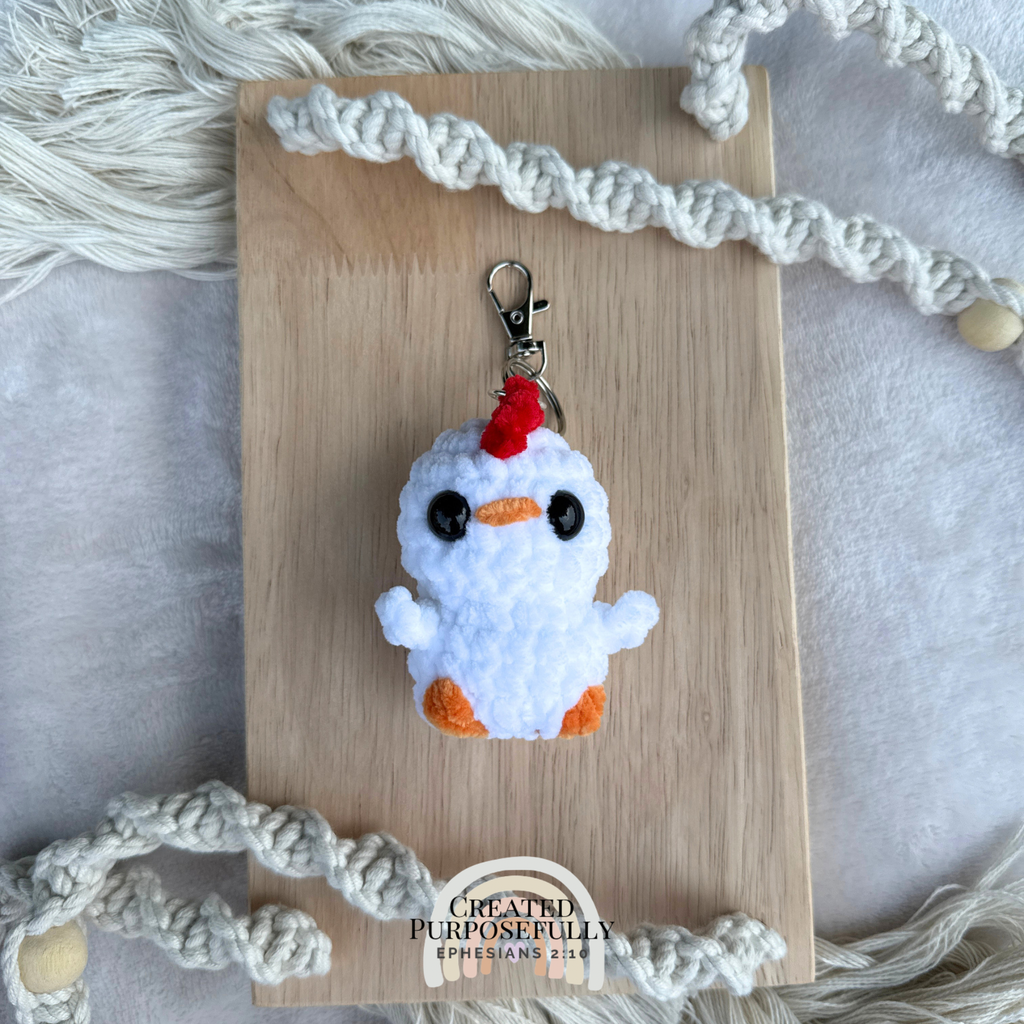 Handmade crochet chicken backpack buddy keychain made with soft plush yarn, a cute bag charm for backpacks, purses, keys, and gifts.
