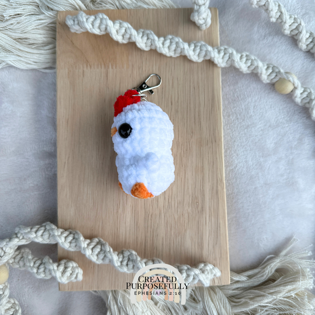 Handmade crochet chicken backpack buddy keychain made with soft plush yarn, a cute bag charm for backpacks, purses, keys, and gifts.