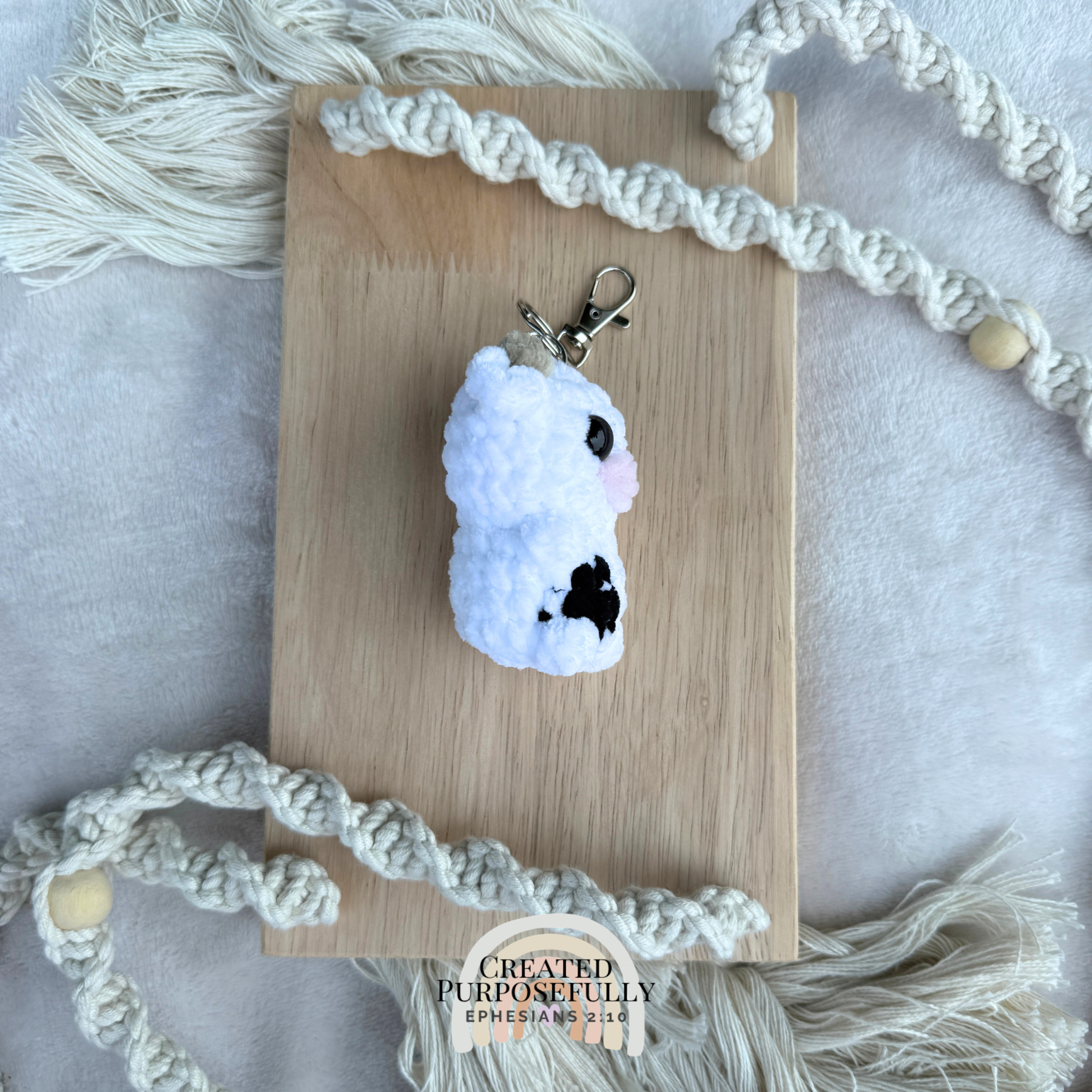 Handmade crochet cow backpack buddy keychain in multiple colors, made with soft plush yarn for backpacks, purses, keys, and gifts.
