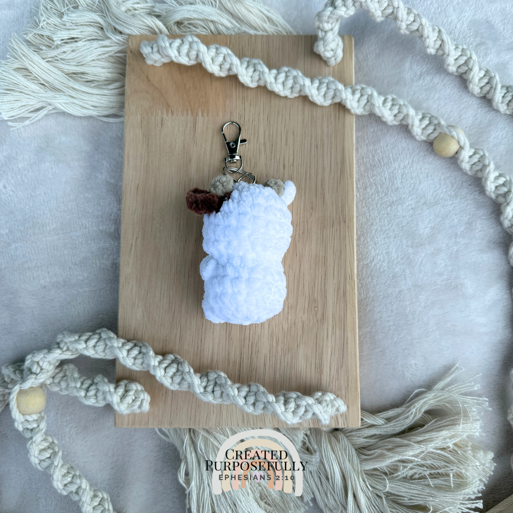 Handmade crochet cow backpack buddy keychain in multiple colors, made with soft plush yarn for backpacks, purses, keys, and gifts.