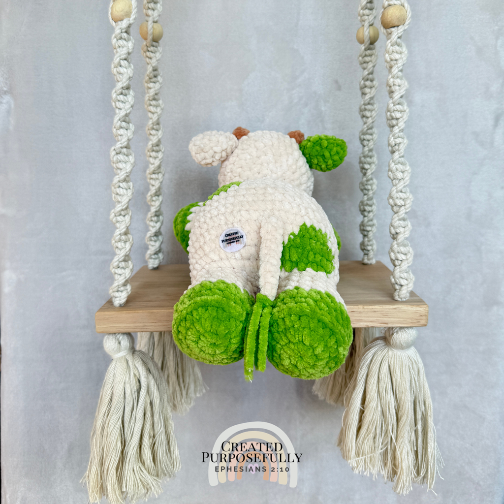 Handmade crochet cow plush made with soft plush yarn and adorable handmade details
