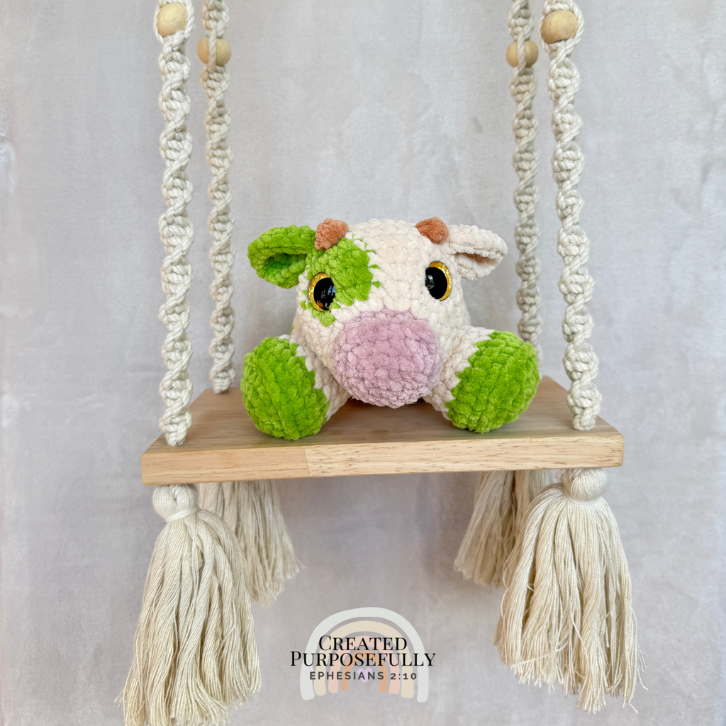 Handmade crochet cow plush made with soft plush yarn and adorable handmade details