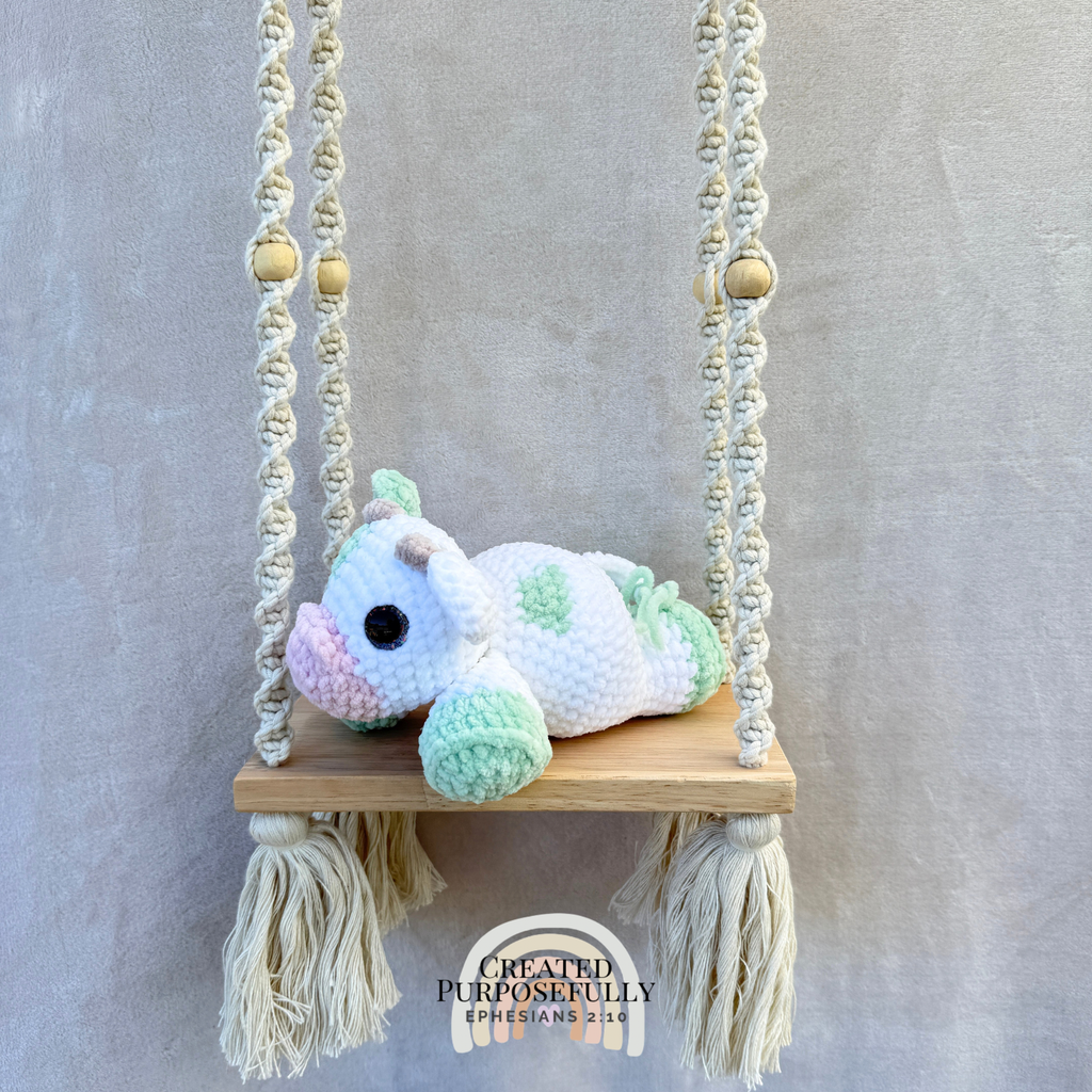 Handmade crochet cow plush made with soft plush yarn and adorable handmade details