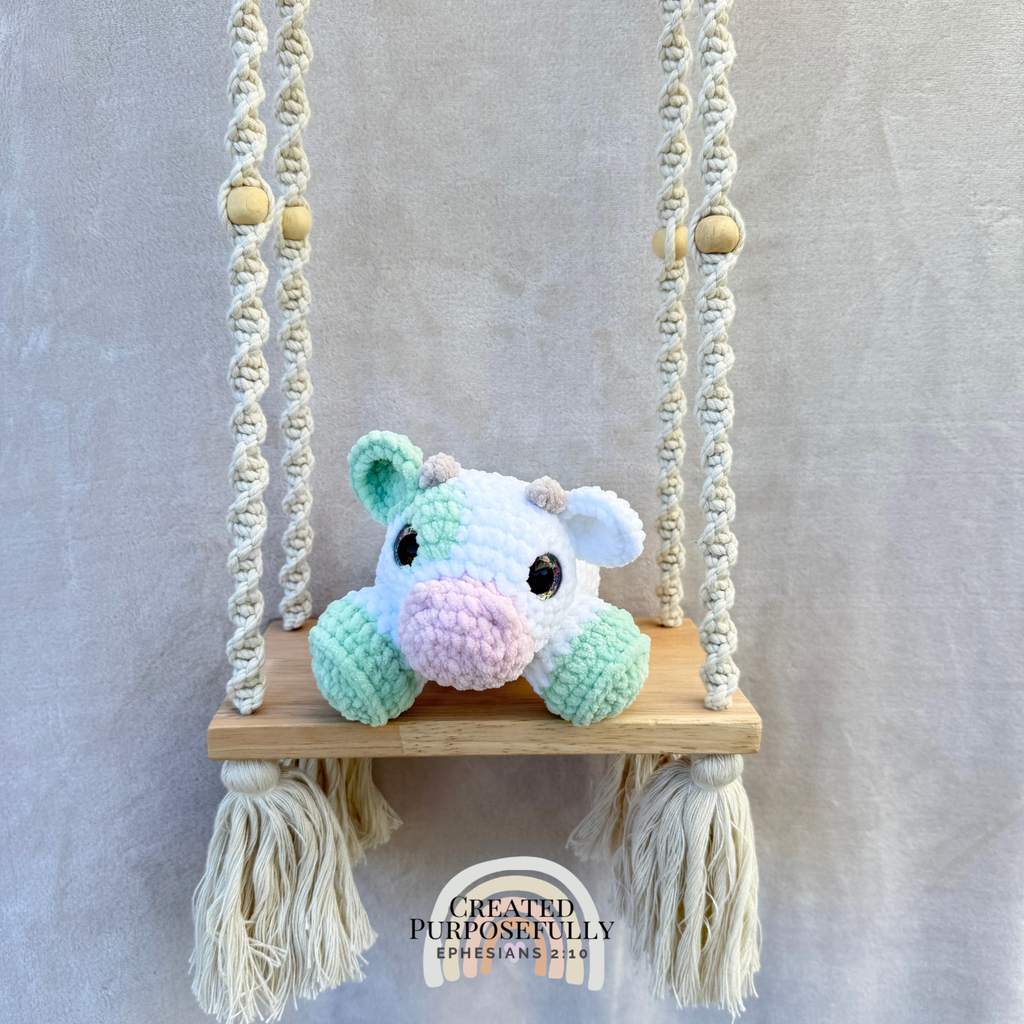 Handmade crochet cow plush made with soft plush yarn and adorable handmade details