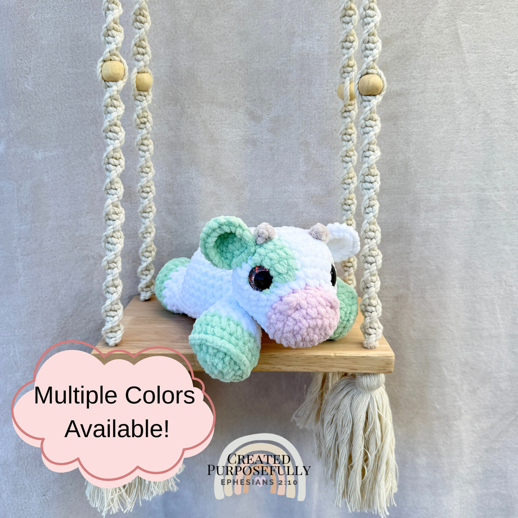 Handmade crochet cow plush made with soft plush yarn and adorable handmade details