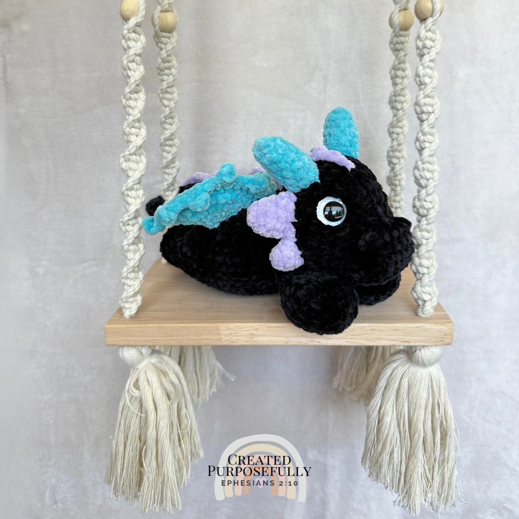 Handmade crochet dragon plush made with soft plush yarn featuring wings and adorable handmade details