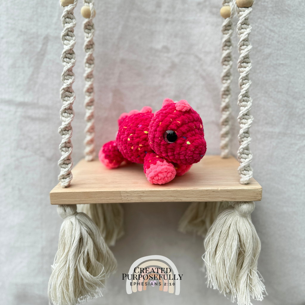 Handmade crochet mini Stegosaurus plush made with soft plush yarn, a cute stuffed dinosaur gift for kids, dino lovers, and plush collectors.