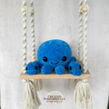 Handmade crochet octopus family plush with one mama octopus and two baby octopuses made with soft blue plush yarn