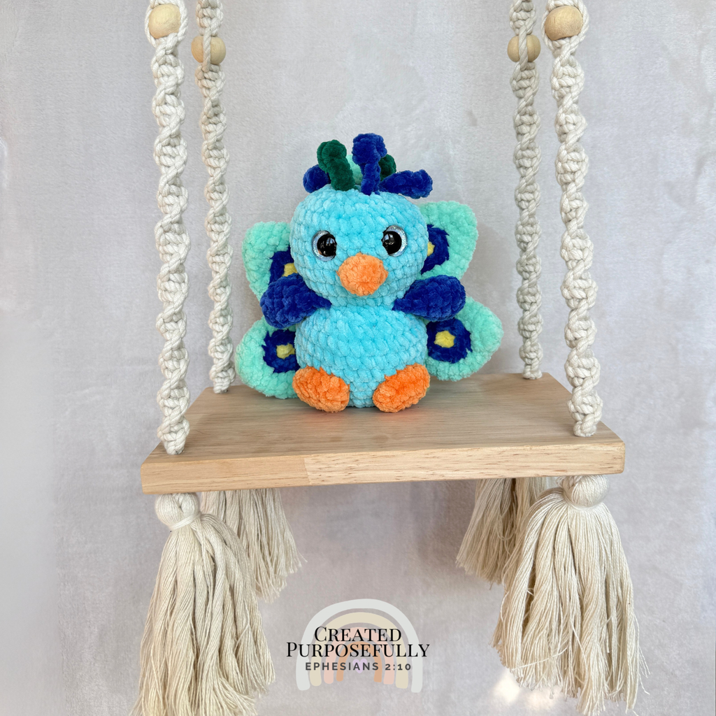 Handmade crochet peacock plush made with soft plush yarn and colorful handmade details