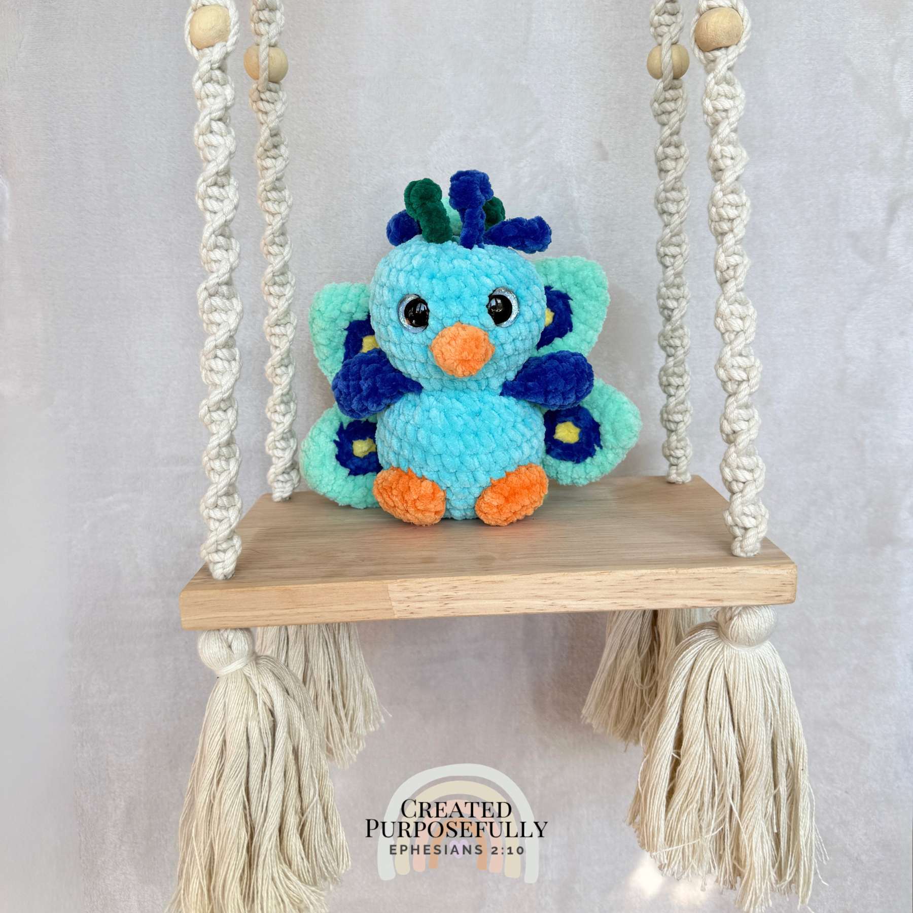 Handmade crochet peacock plush made with soft plush yarn and colorful handmade details