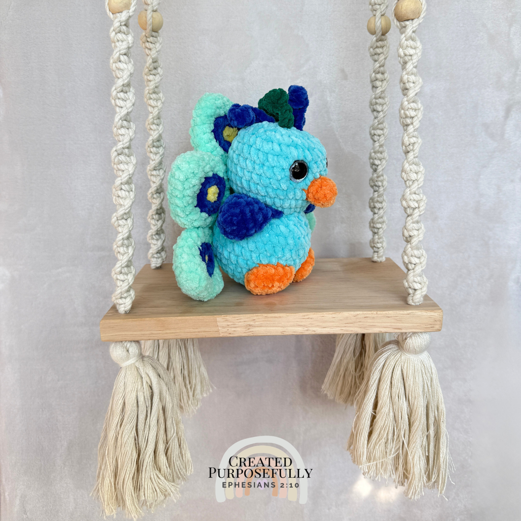 Handmade crochet peacock plush made with soft plush yarn and colorful handmade details