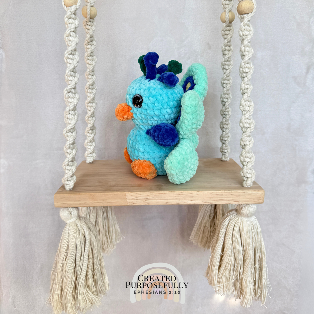 Handmade crochet peacock plush made with soft plush yarn and colorful handmade details