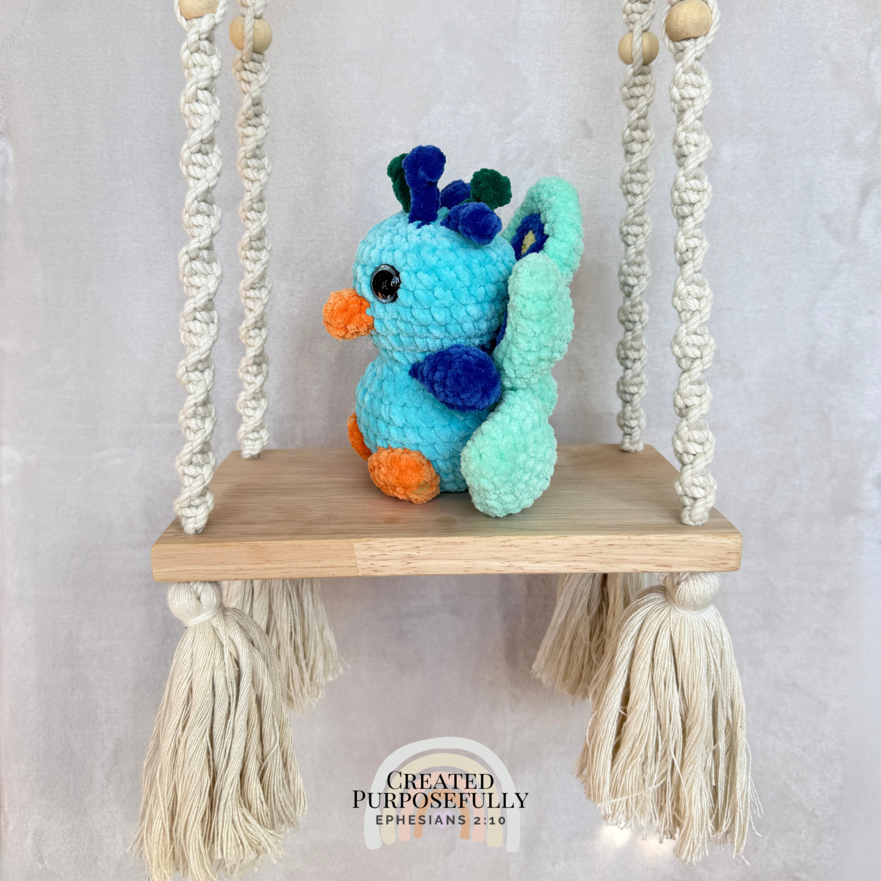 Handmade crochet peacock plush made with soft plush yarn and colorful handmade details