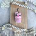 Handmade crochet pig backpack buddy keychain made with soft plush yarn, a cute bag charm for backpacks, purses, keys, and gifts.