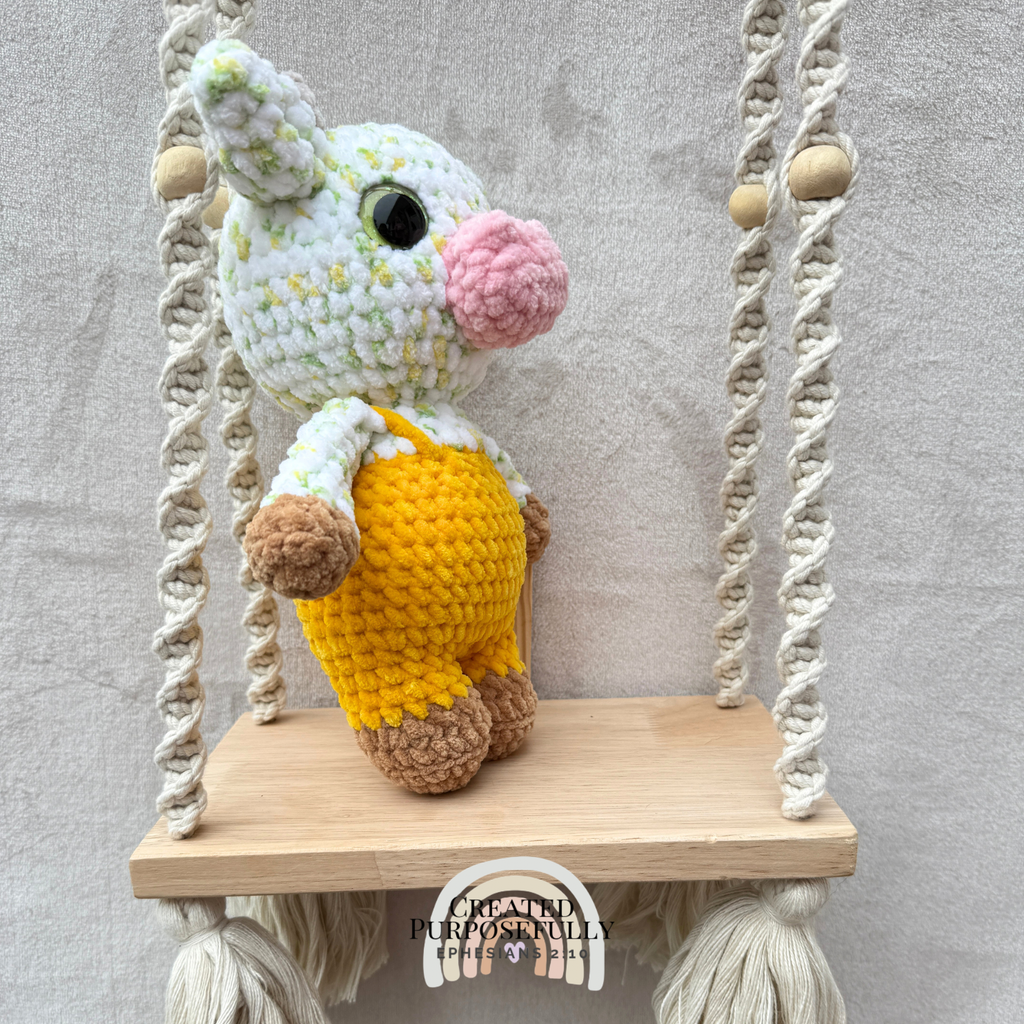 Handmade crochet standing cow made with ultra soft plush yarn. Choose purple, pink, or blue overalls. A sweet gift for cow lovers of all ages.