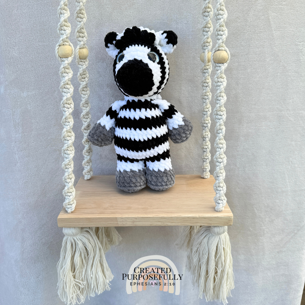 Handmade crochet zebra plush with fun stripes made with soft cuddly yarn by Created Purposefully