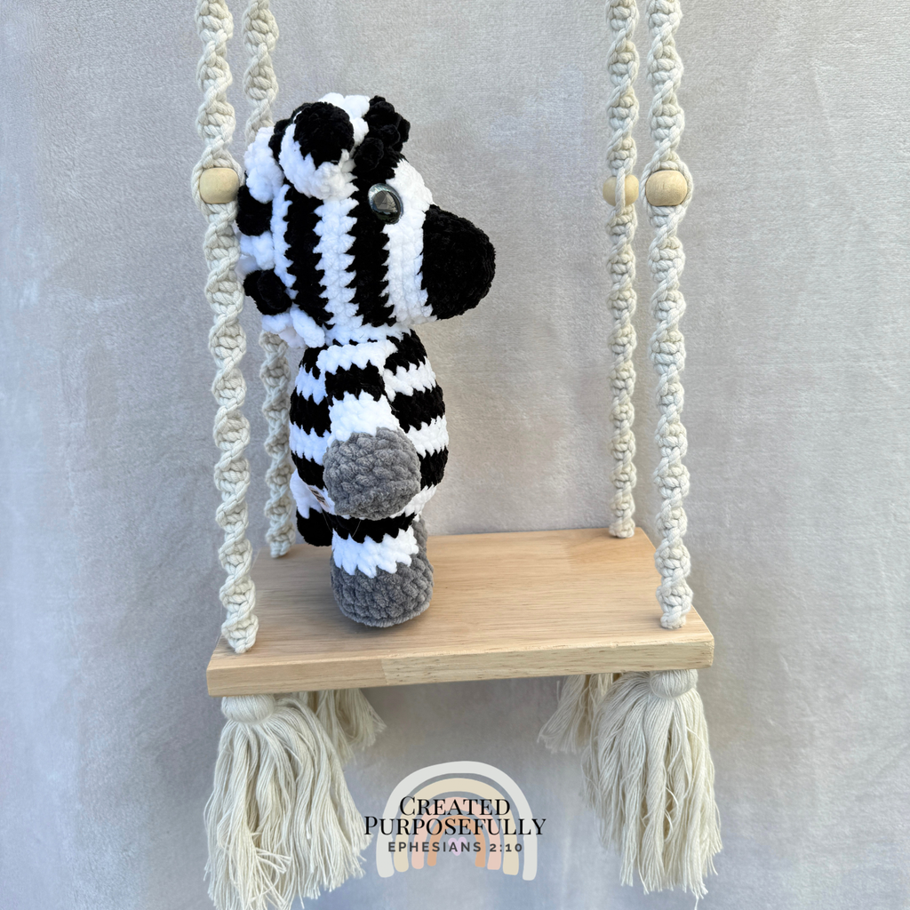 Handmade crochet zebra plush with fun stripes made with soft cuddly yarn by Created Purposefully