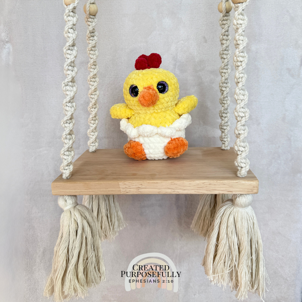 Handmade hatching chick crochet plush peeking from an eggshell made with soft plush yarn