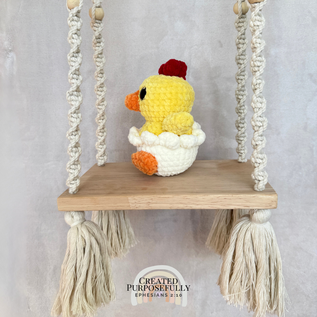 Handmade hatching chick crochet plush peeking from an eggshell made with soft plush yarn