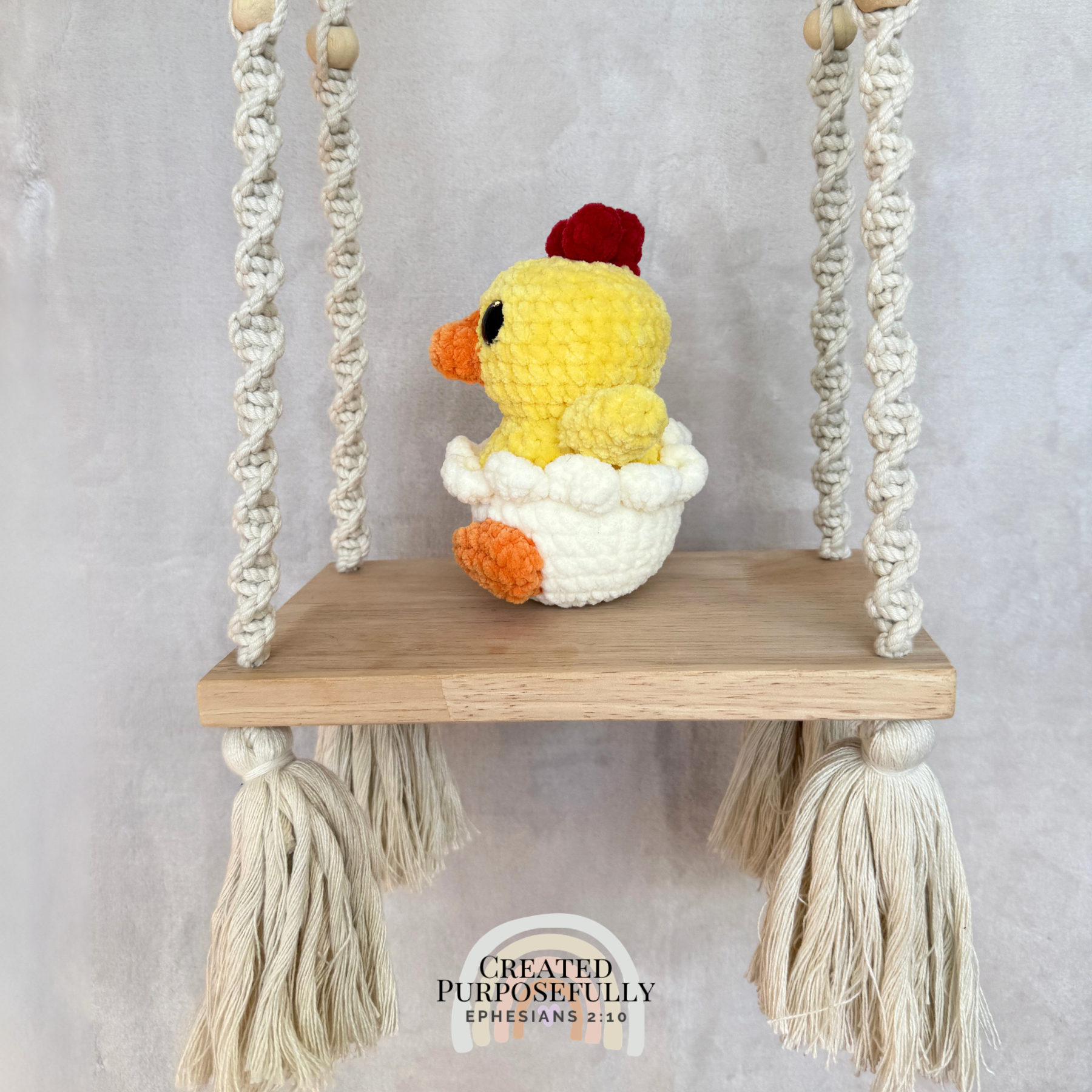 Handmade hatching chick crochet plush peeking from an eggshell made with soft plush yarn