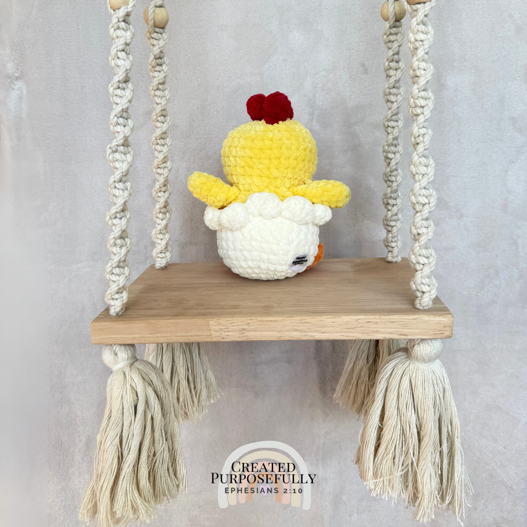 Handmade hatching chick crochet plush peeking from an eggshell made with soft plush yarn