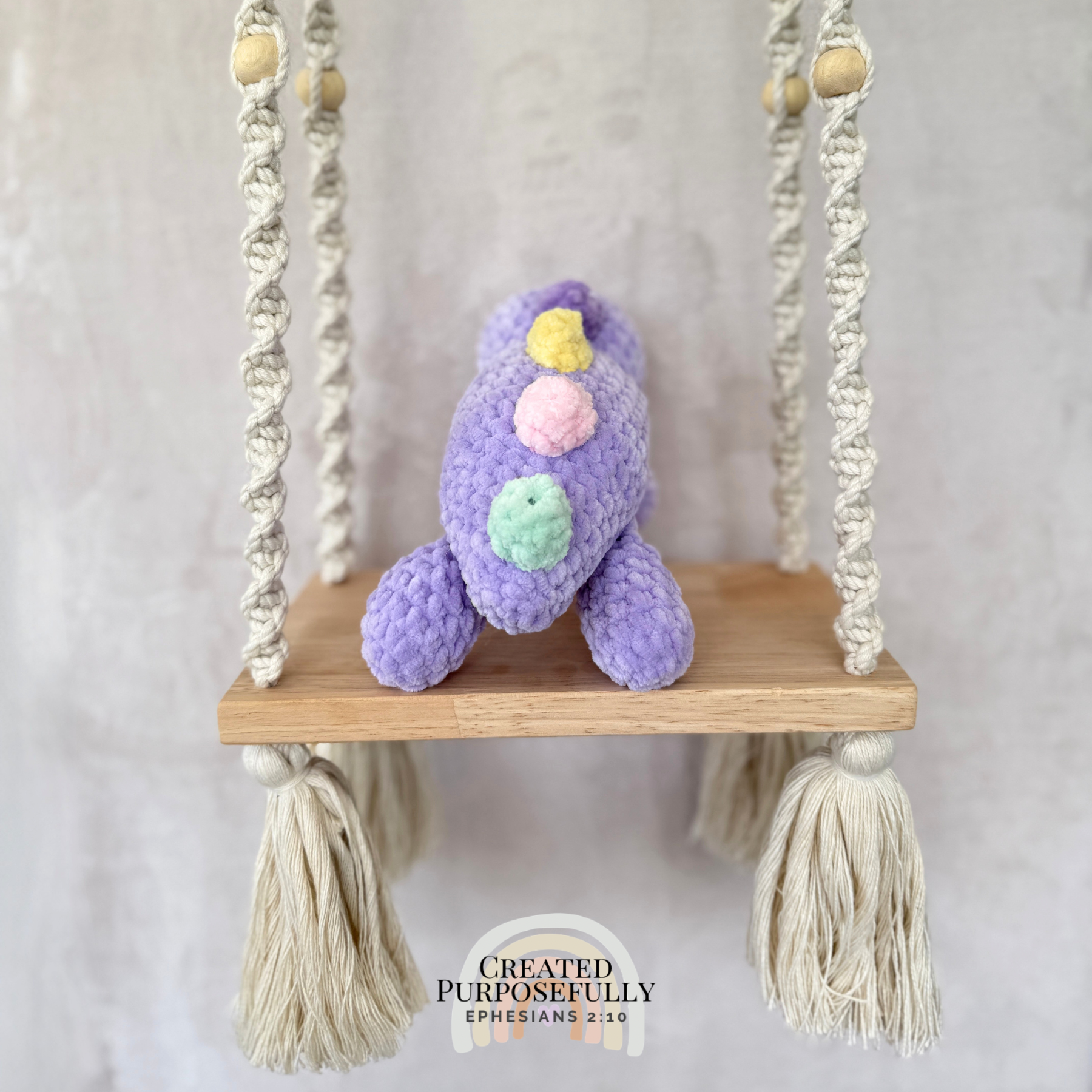 Handmade laying stegosaurus plush made with soft plush yarn and adorable dinosaur details