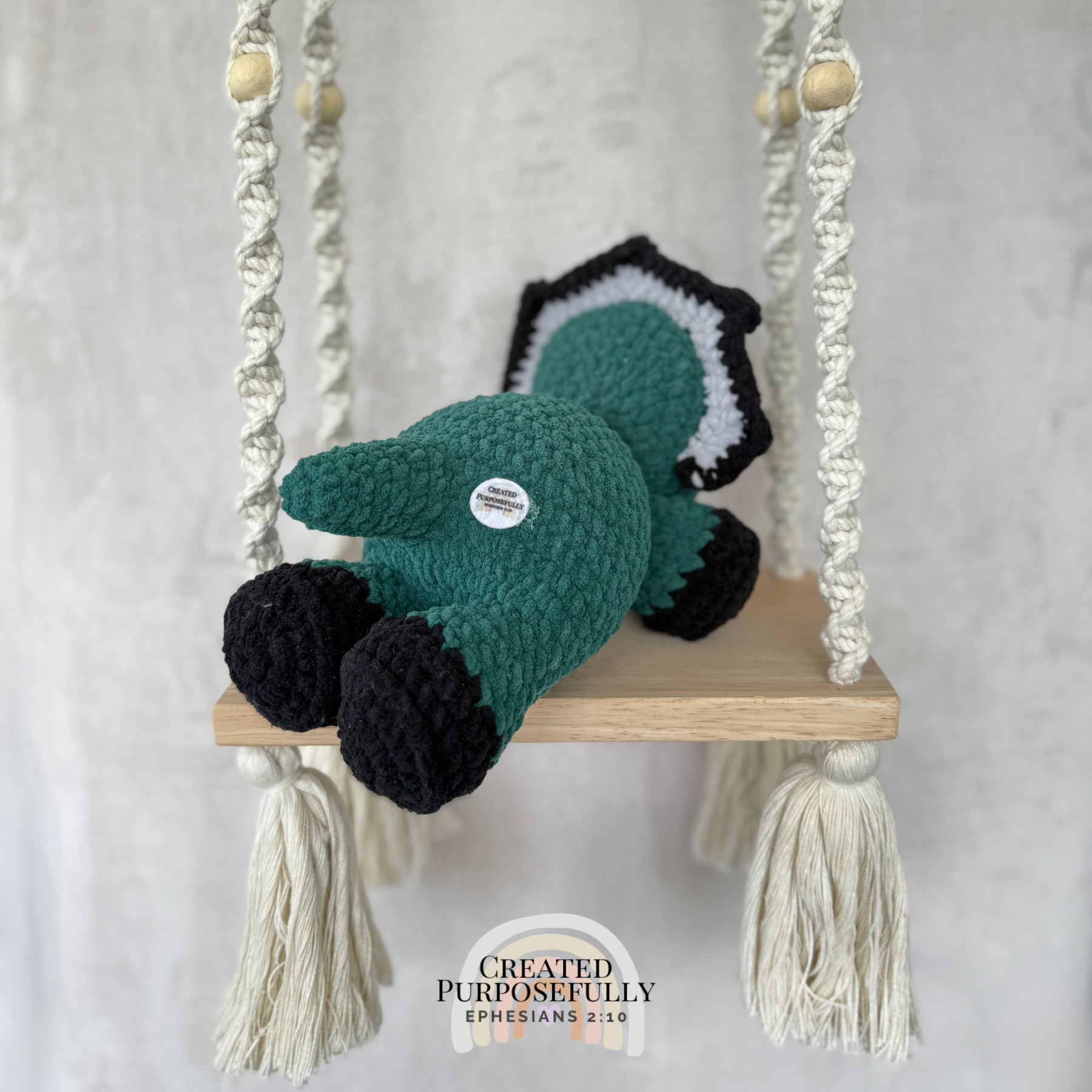 Handmade laying triceratops crochet plush made with soft plush yarn and adorable dinosaur details