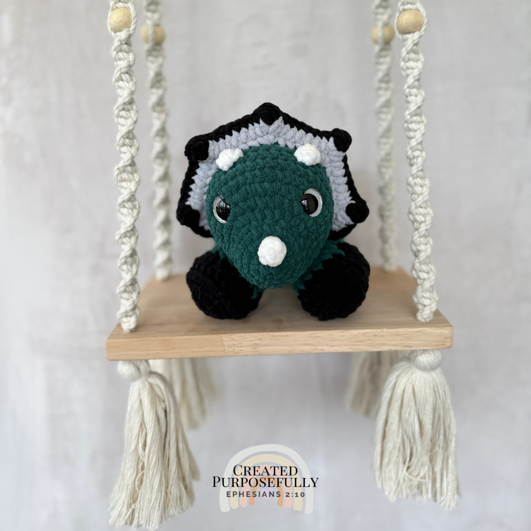 Handmade laying triceratops crochet plush made with soft plush yarn and adorable dinosaur details
