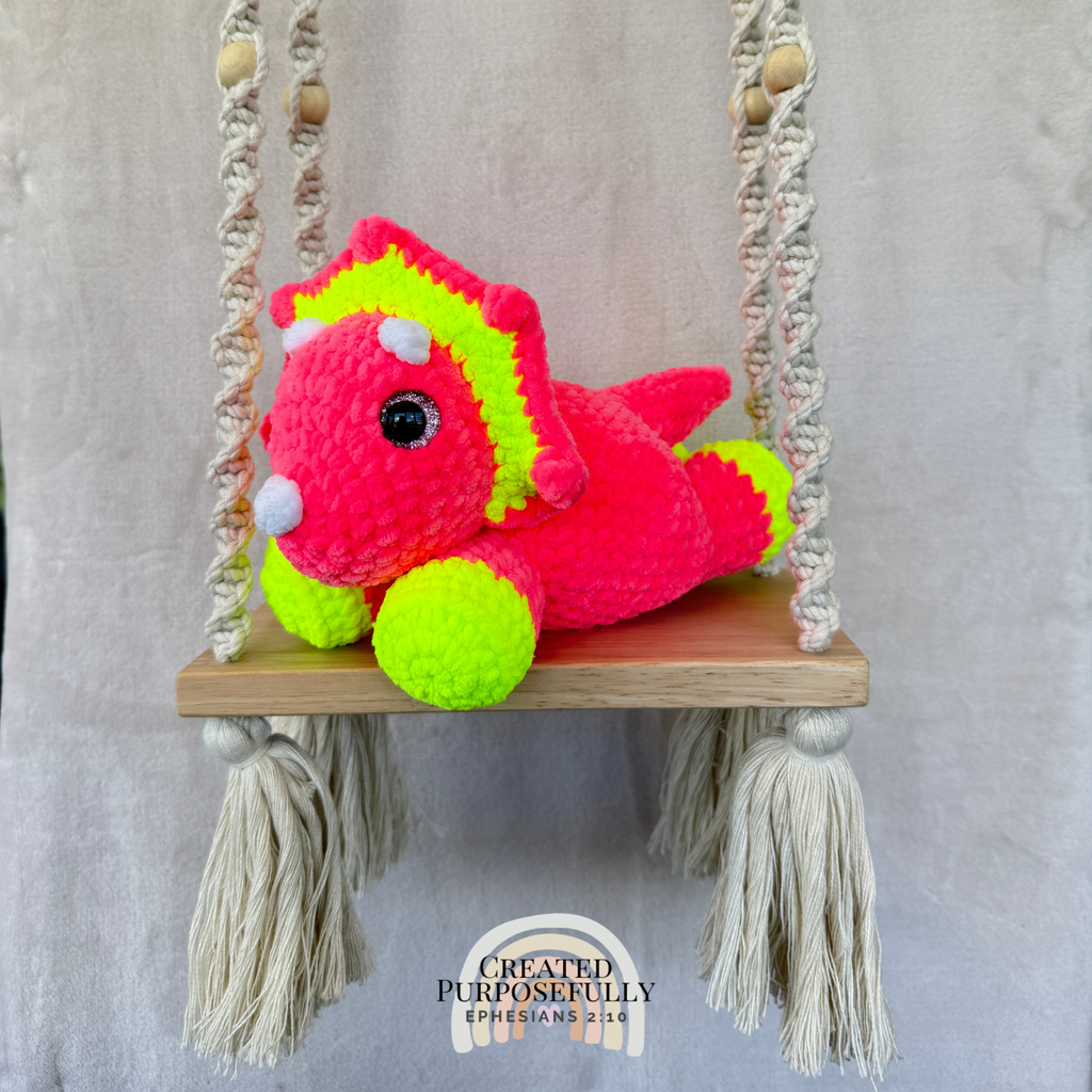 Handmade laying triceratops crochet plush made with soft plush yarn and adorable dinosaur details