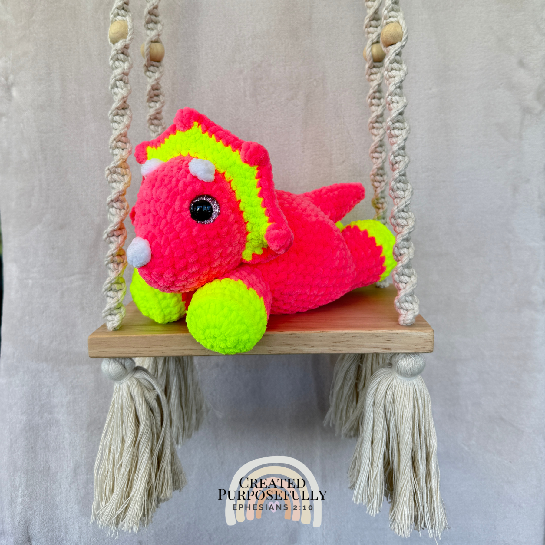 Handmade laying triceratops crochet plush made with soft plush yarn and adorable dinosaur details