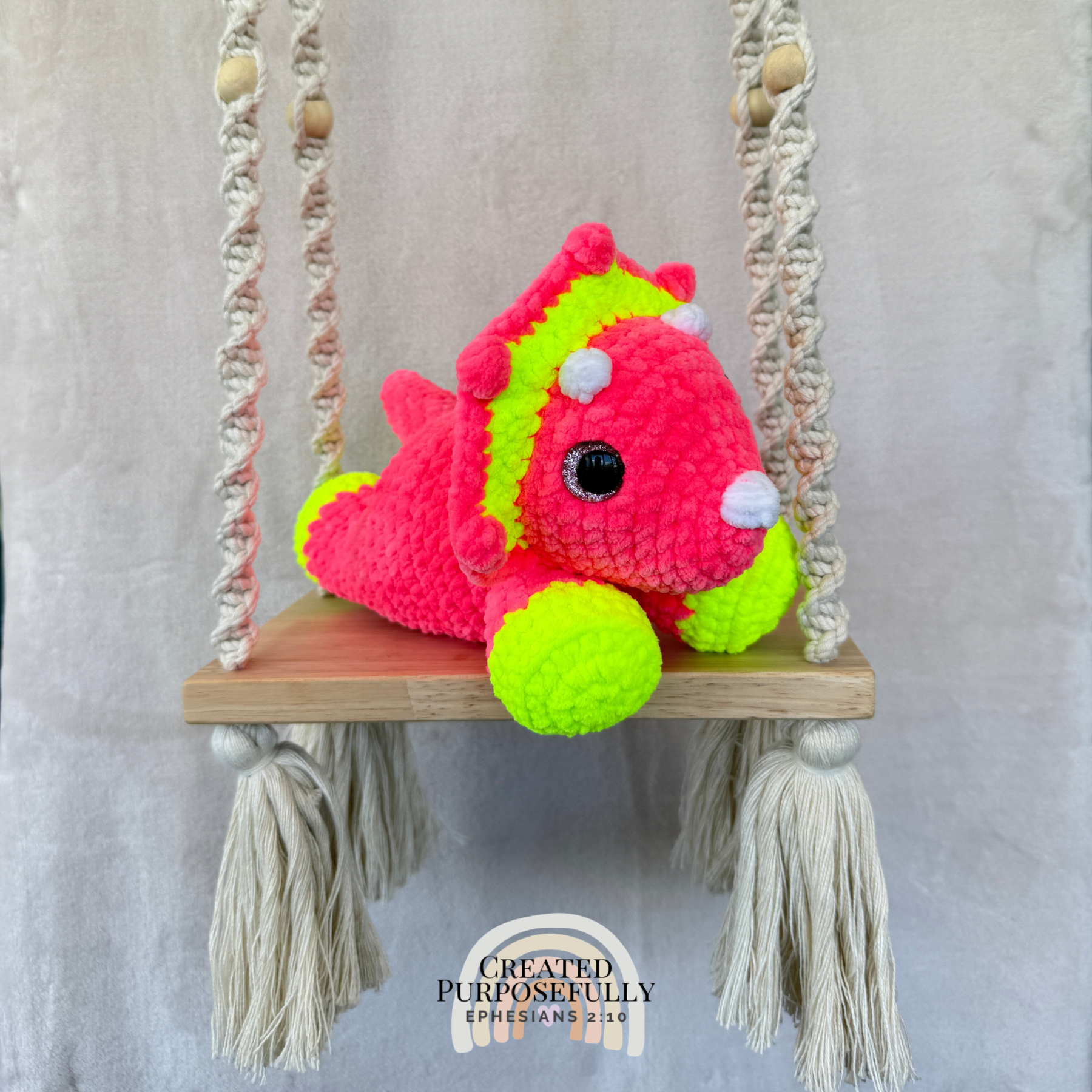Handmade laying triceratops crochet plush made with soft plush yarn and adorable dinosaur details