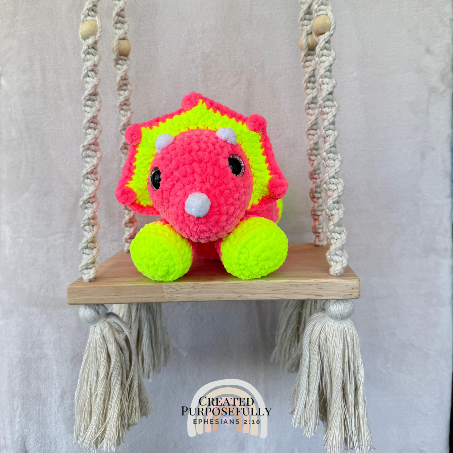 Handmade laying triceratops crochet plush made with soft plush yarn and adorable dinosaur details