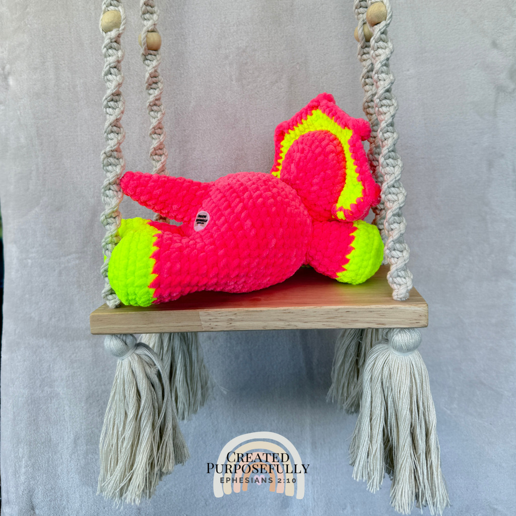 Handmade laying triceratops crochet plush made with soft plush yarn and adorable dinosaur details