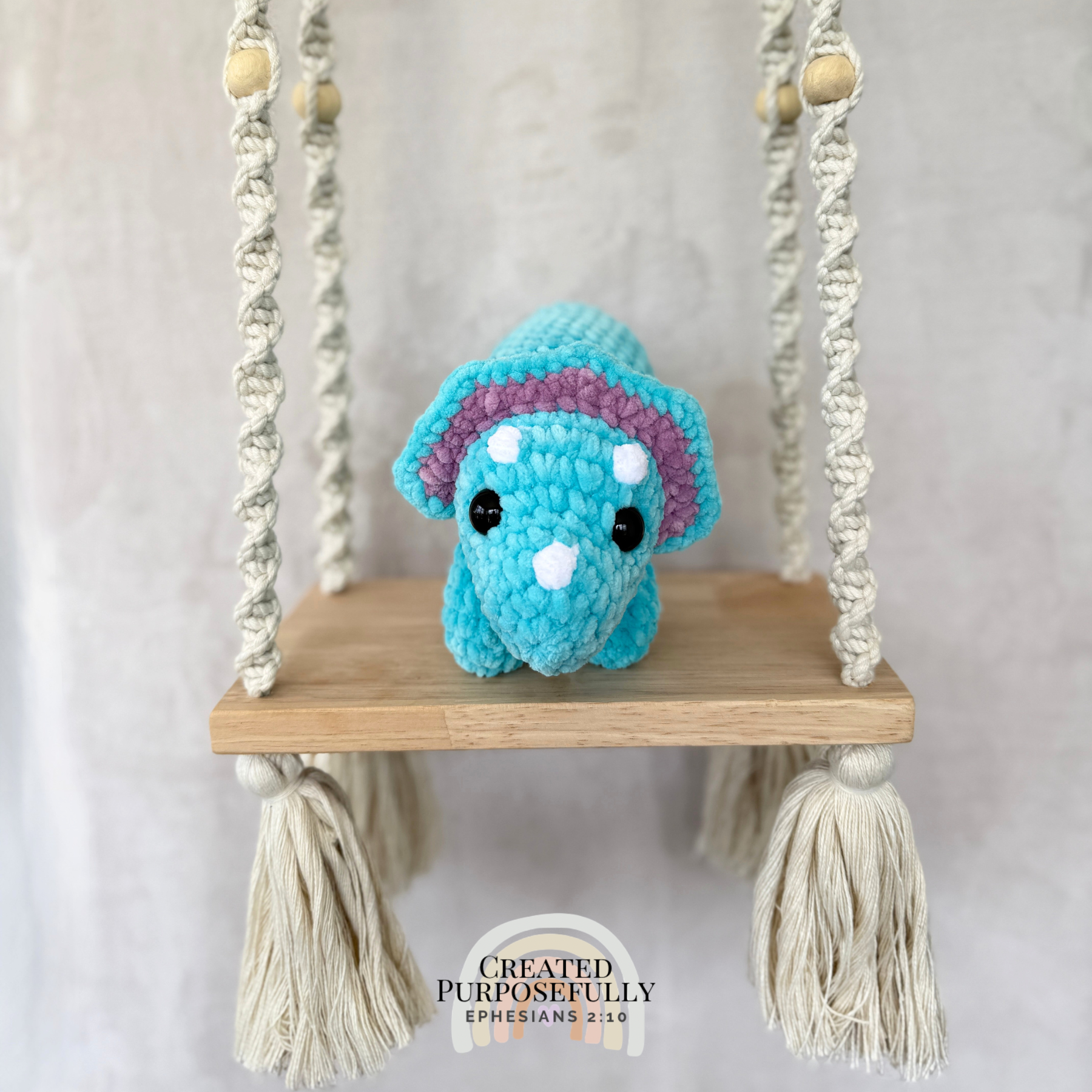 Handmade laying triceratops plush made with soft plush yarn and adorable dinosaur details
