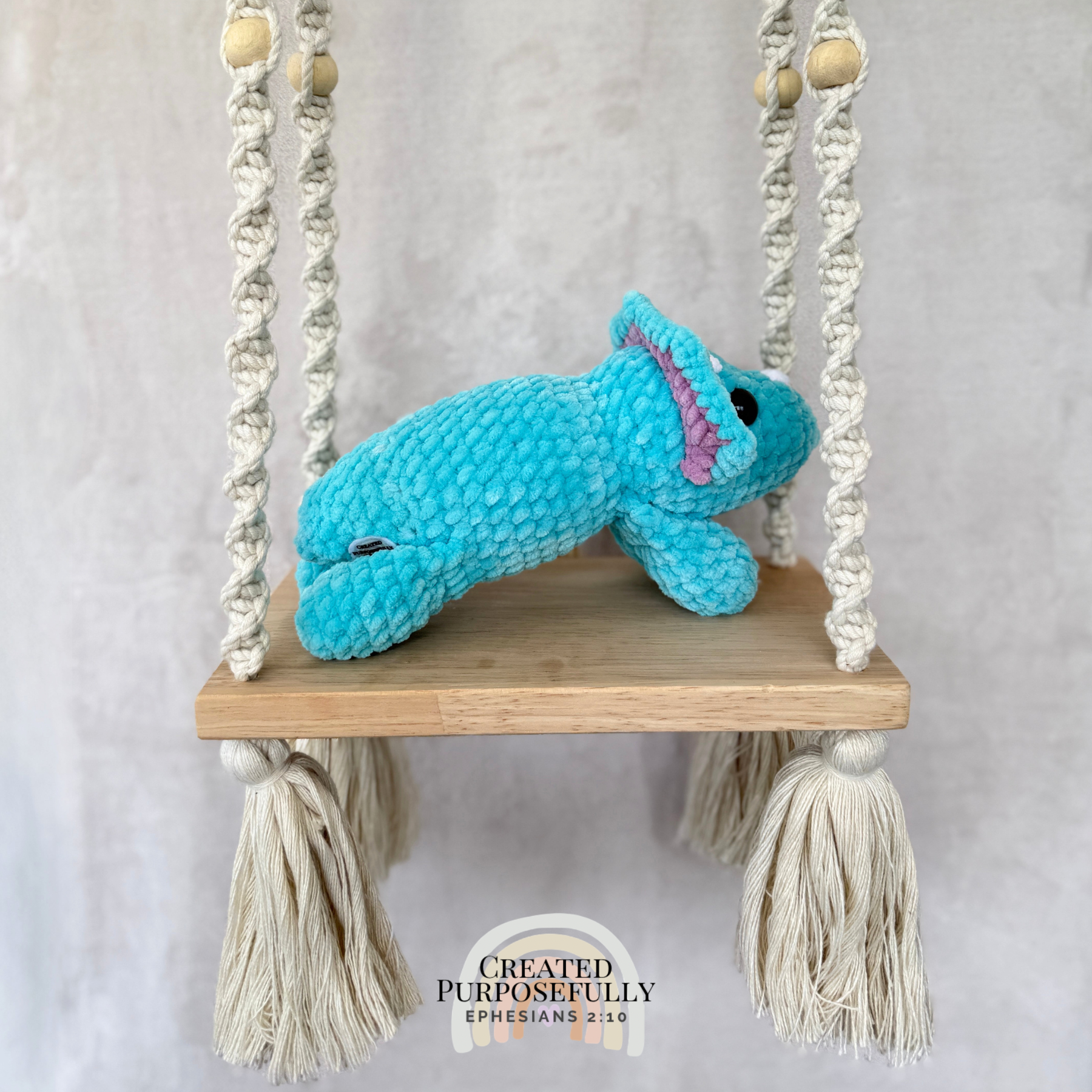 Handmade laying triceratops plush made with soft plush yarn and adorable dinosaur details