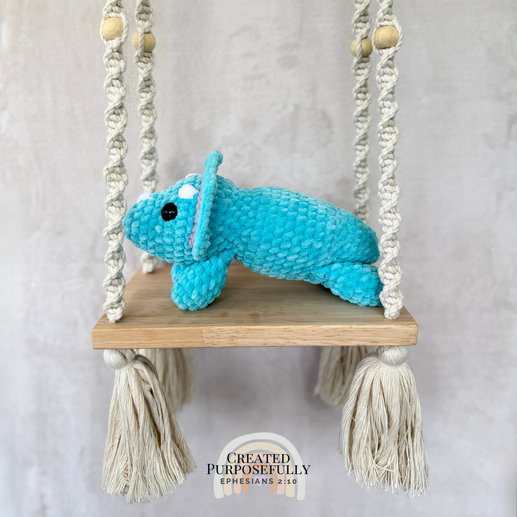 Handmade laying triceratops plush made with soft plush yarn and adorable dinosaur details