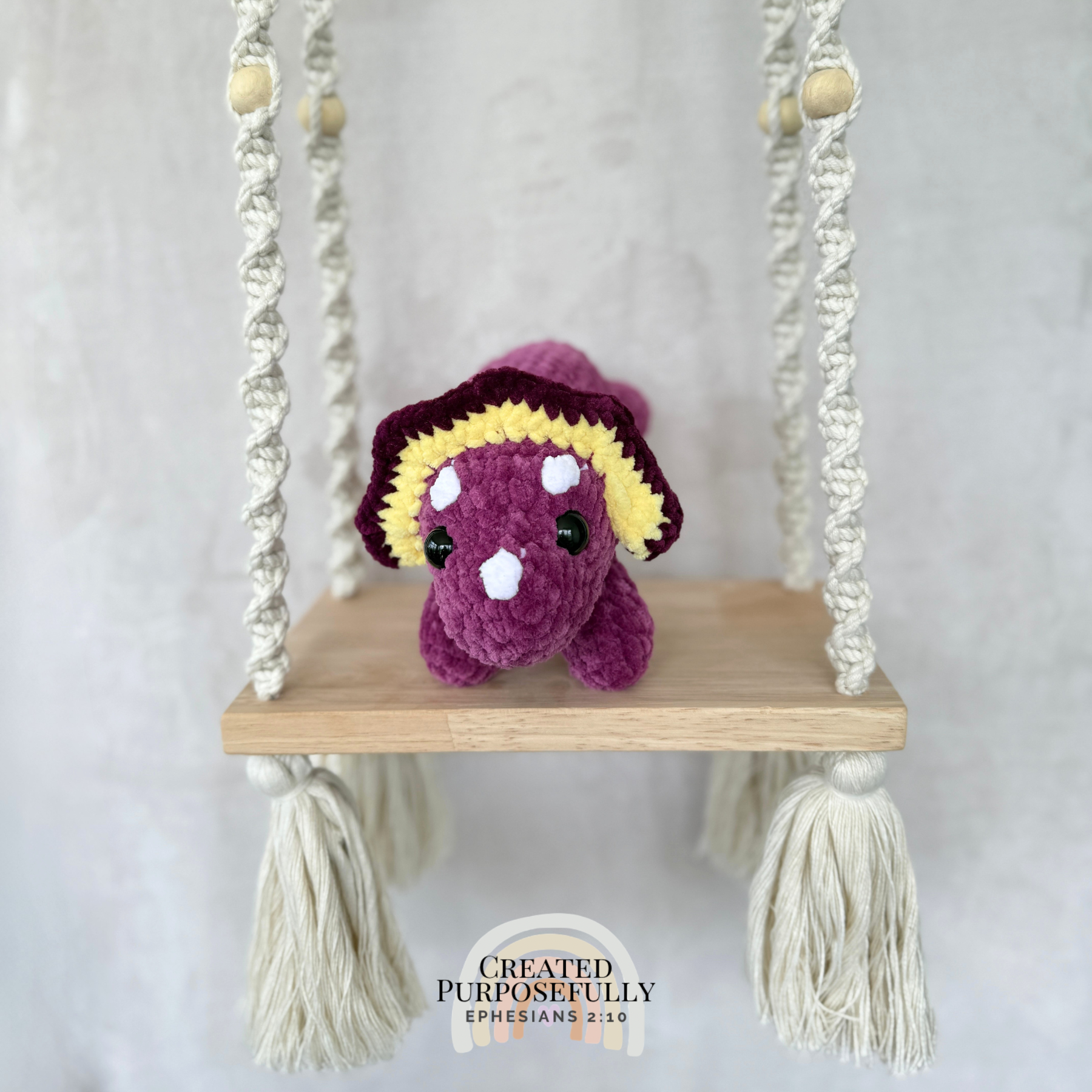Handmade laying triceratops plush made with soft plush yarn and adorable dinosaur details