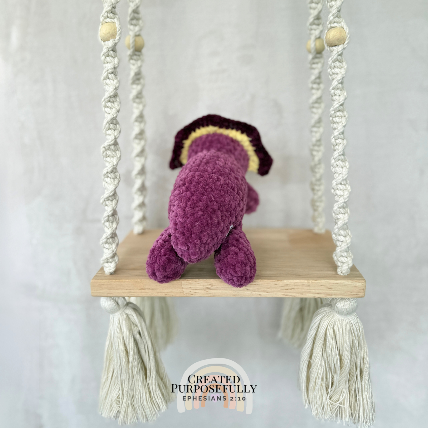 Handmade laying triceratops plush made with soft plush yarn and adorable dinosaur details